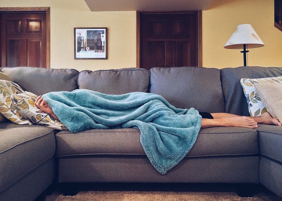 person laying on couch sick